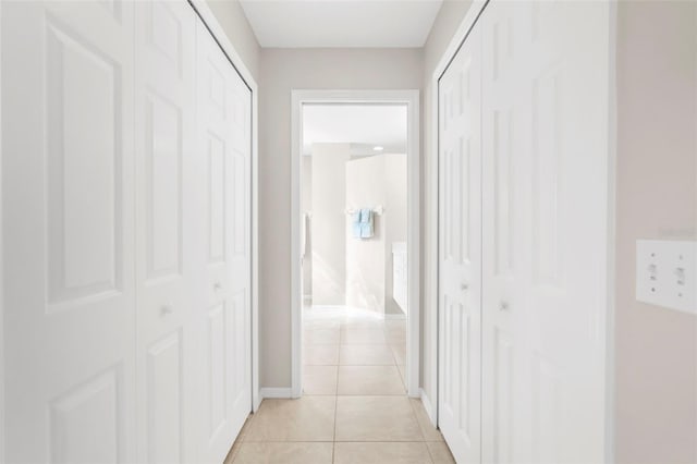 hall featuring light tile patterned flooring