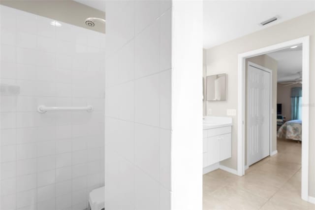 bathroom featuring vanity, toilet, and tile patterned flooring