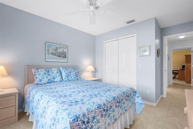 bedroom featuring light tile patterned floors, a closet, and ceiling fan