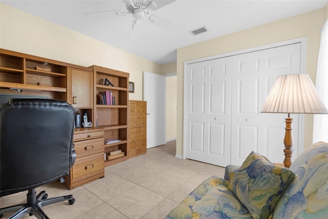 office space with light tile patterned floors and ceiling fan