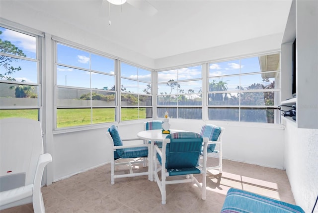 sunroom featuring ceiling fan