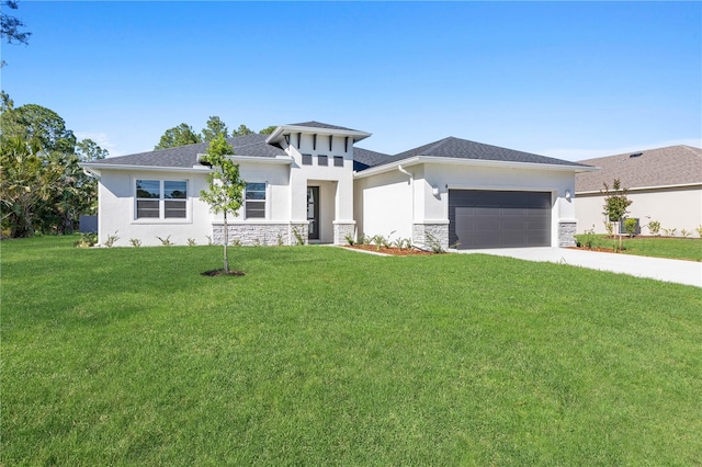 prairie-style home with a front lawn and a garage