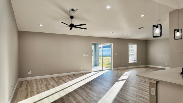 interior space featuring ceiling fan, light hardwood / wood-style flooring, and lofted ceiling