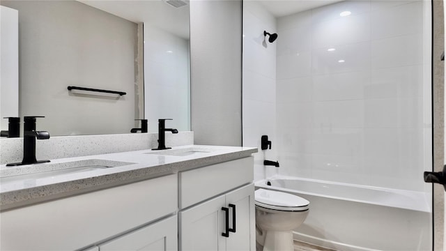 full bathroom with vanity, toilet, and tiled shower / bath