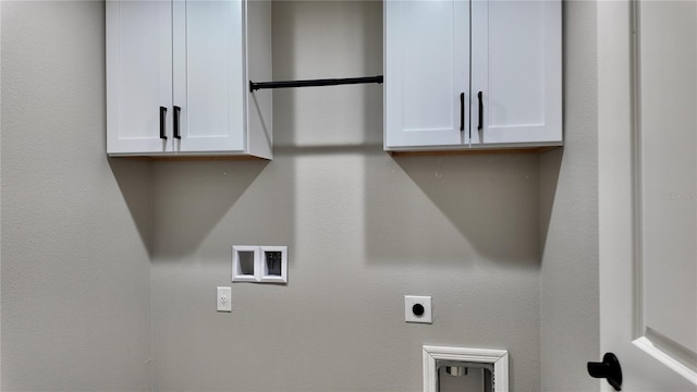 laundry room with electric dryer hookup, cabinets, and hookup for a washing machine