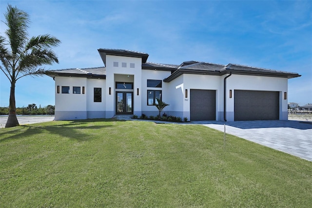 prairie-style home with a front yard and a garage