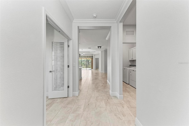 1269 Backspin Dr, Englewood, FL 34223 - hall featuring baseboards, washer and dryer, ornamental molding, and light wood finished floors