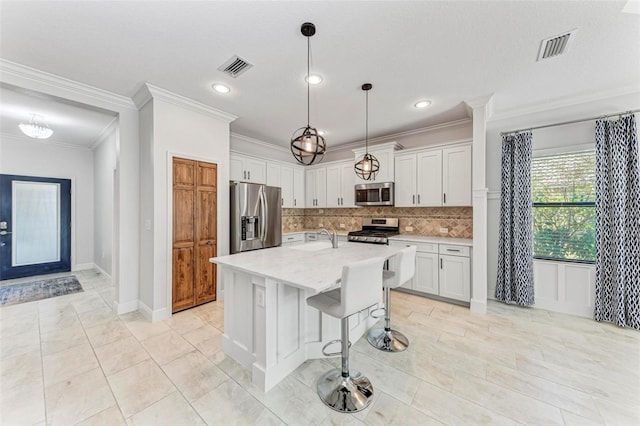 1269 Backspin Dr, Englewood, FL 34223 - kitchen with a sink, decorative backsplash, crown molding, white cabinets, and appliances with stainless steel finishes