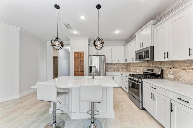 1269 Backspin Dr, Englewood, FL 34223 - kitchen with light stone countertops, decorative backsplash, stainless steel appliances, a center island, and visible vents
