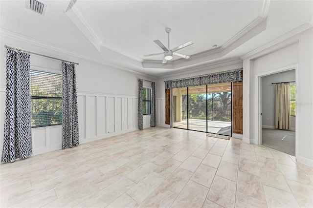 1269 Backspin Dr, Englewood, FL 34223 - spare room featuring visible vents, ornamental molding, a ceiling fan, and a tray ceiling