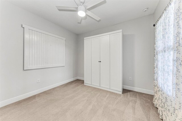 1269 Backspin Dr, Englewood, FL 34223 - unfurnished bedroom featuring baseboards, ceiling fan, a closet, and carpet