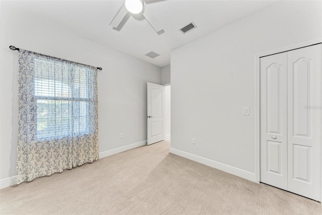 1269 Backspin Dr, Englewood, FL 34223 - unfurnished bedroom with carpet floors, a closet, baseboards, visible vents, and a ceiling fan