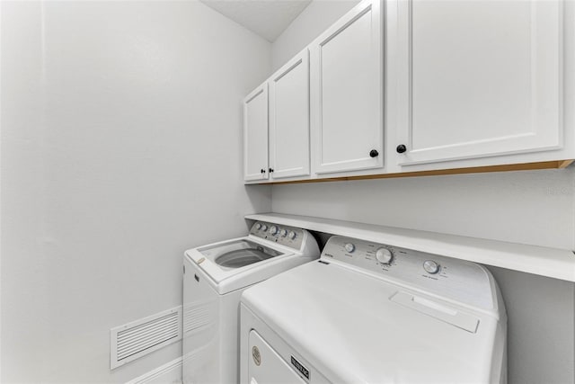 1269 Backspin Dr, Englewood, FL 34223 - laundry room featuring visible vents, cabinet space, and washing machine and dryer