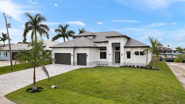 view of front facade with a front yard and a garage