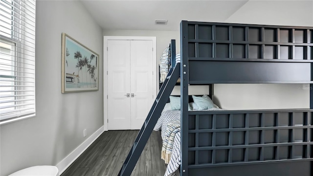 bedroom with a closet and dark hardwood / wood-style flooring