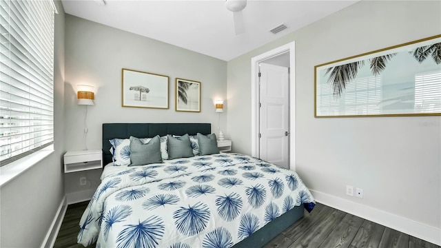 bedroom with dark wood-type flooring, ceiling fan, and multiple windows