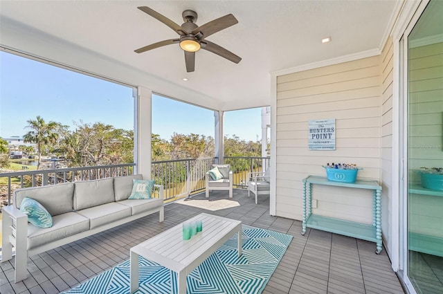 sunroom / solarium featuring ceiling fan