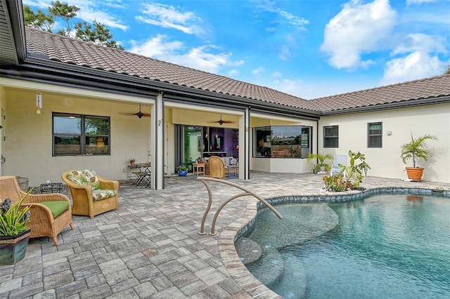 view of swimming pool featuring ceiling fan, an outdoor hangout area, and a patio area