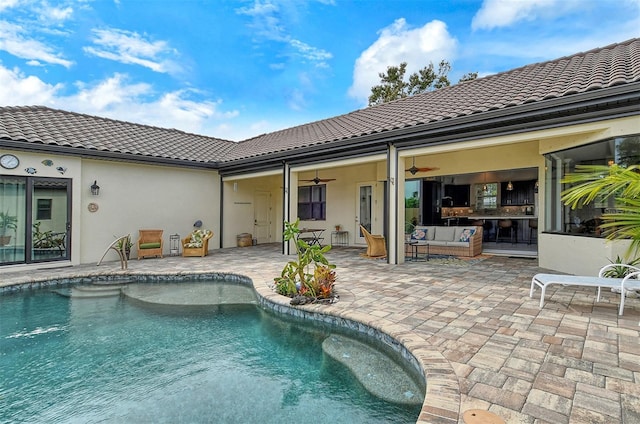 view of pool with ceiling fan, an outdoor hangout area, and a patio area