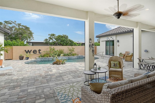 view of patio featuring a fenced in pool, pool water feature, an outdoor living space, and ceiling fan