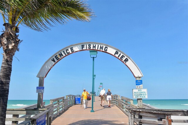 surrounding community with a beach view and a water view