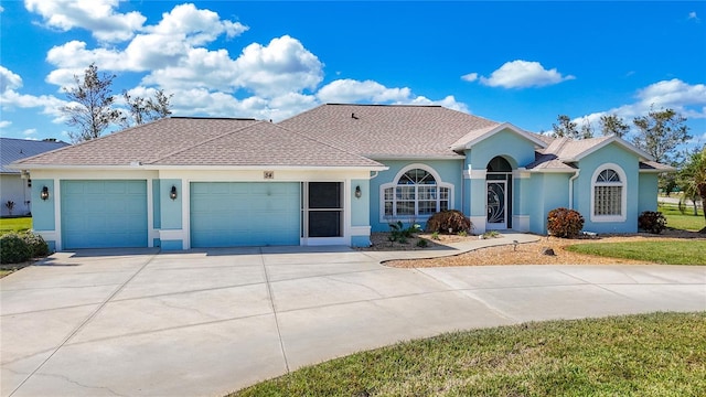 ranch-style house with a front yard and a garage