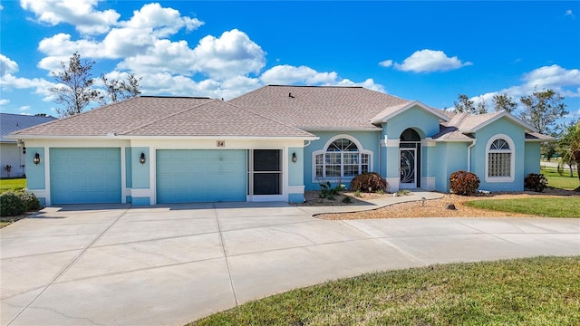 ranch-style house with concrete driveway, stucco siding, and a garage