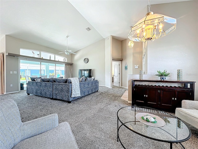 carpeted living area featuring baseboards, visible vents, high vaulted ceiling, and ceiling fan with notable chandelier