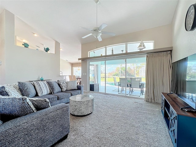 carpeted living room with ceiling fan