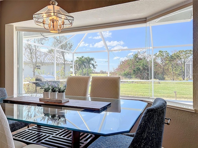 dining space featuring a textured wall and a chandelier