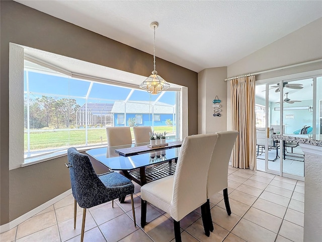 dining area with a healthy amount of sunlight, light tile patterned floors, ceiling fan with notable chandelier, and a textured ceiling