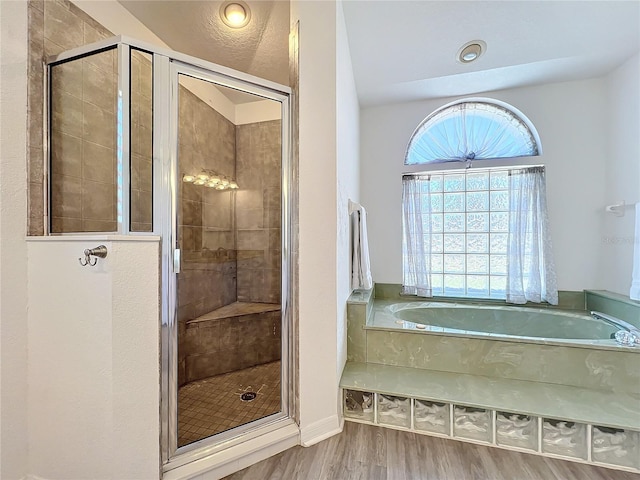 bathroom featuring wood-type flooring and plus walk in shower