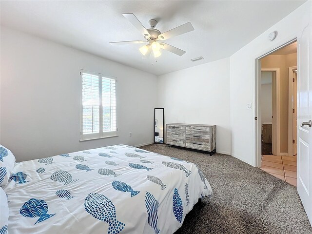 bedroom featuring carpet flooring, a ceiling fan, baseboards, and visible vents