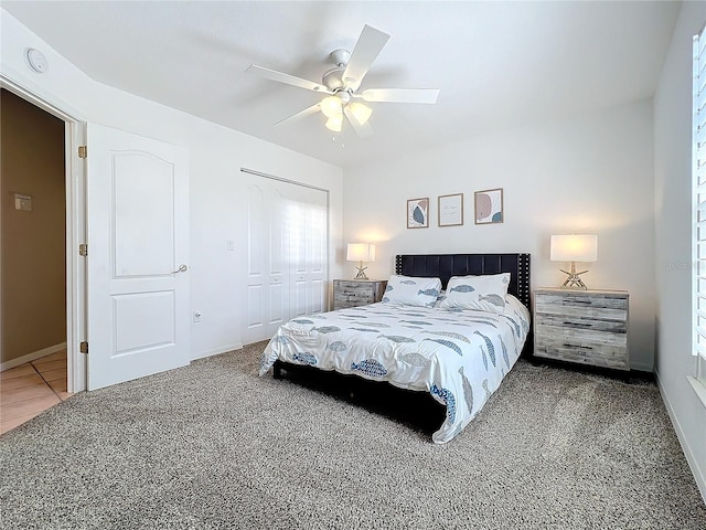 carpeted bedroom featuring a closet and ceiling fan