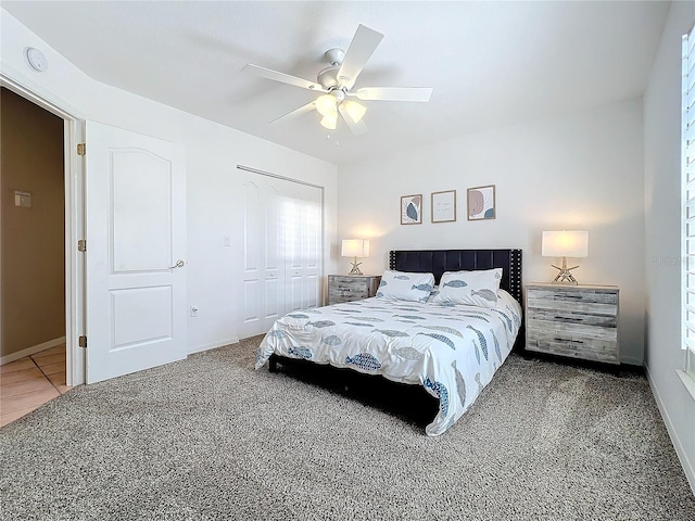 bedroom featuring a ceiling fan, baseboards, carpet, and a closet