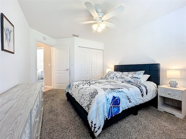 bedroom with a closet, dark carpet, and ceiling fan