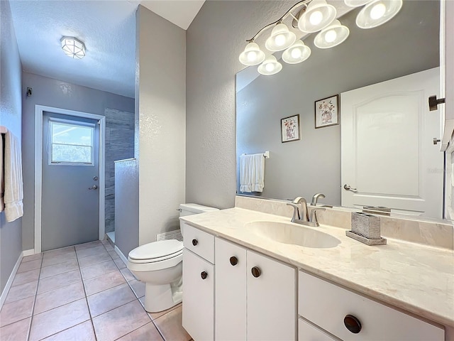 full bathroom with tile patterned flooring, a walk in shower, vanity, toilet, and a textured wall