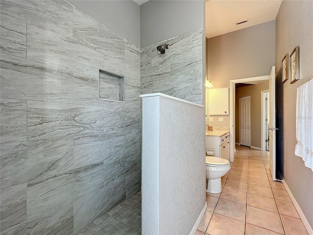 bathroom featuring tile patterned flooring, visible vents, vanity, toilet, and a walk in shower