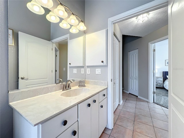 bathroom featuring vanity, a textured ceiling, and tile patterned floors