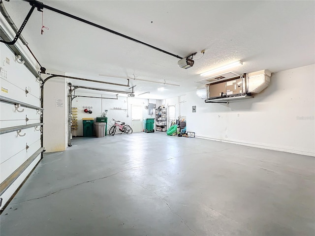 garage with a garage door opener and electric panel