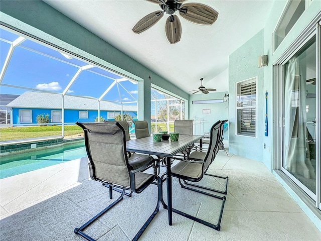 view of patio / terrace with outdoor dining area, glass enclosure, ceiling fan, and an outdoor pool