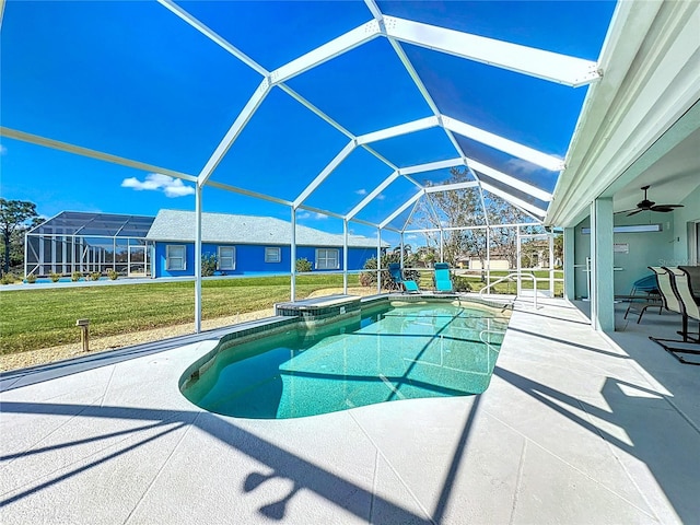 outdoor pool featuring a ceiling fan, a patio area, glass enclosure, a hot tub, and a yard