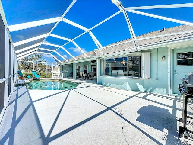 view of swimming pool with a patio area and a lanai