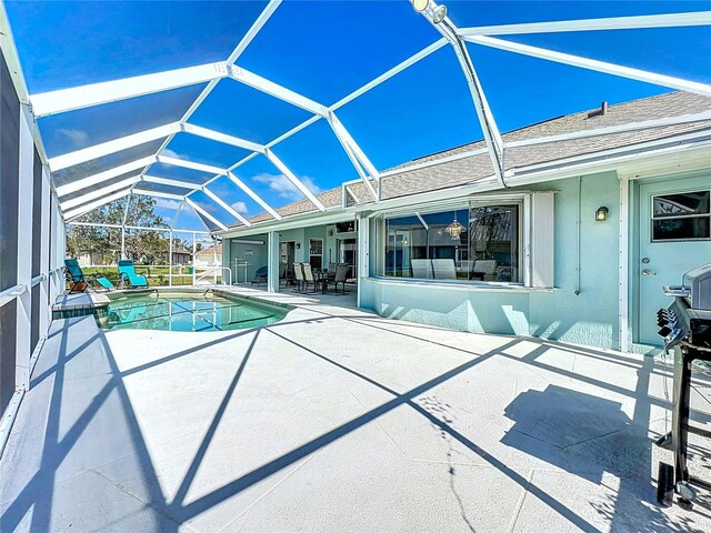 outdoor pool featuring a lanai and a patio