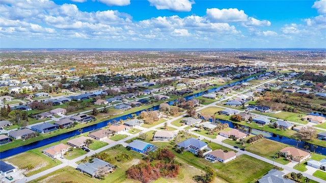 birds eye view of property with a water view and a residential view