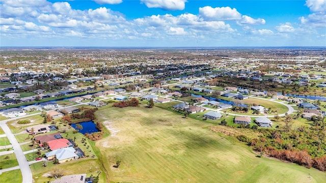 birds eye view of property with a water view, view of golf course, and a residential view