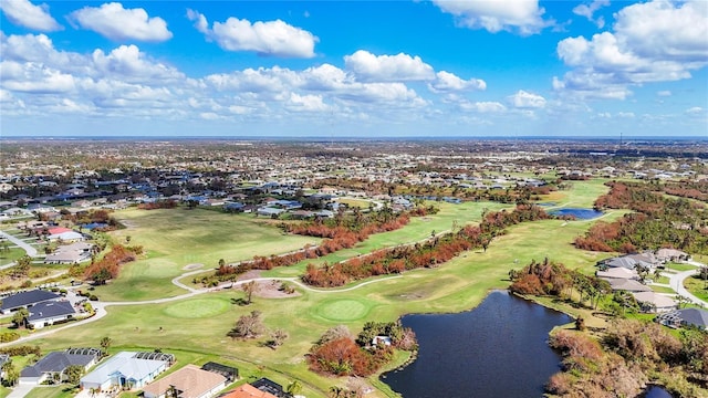drone / aerial view with a water view, view of golf course, and a residential view
