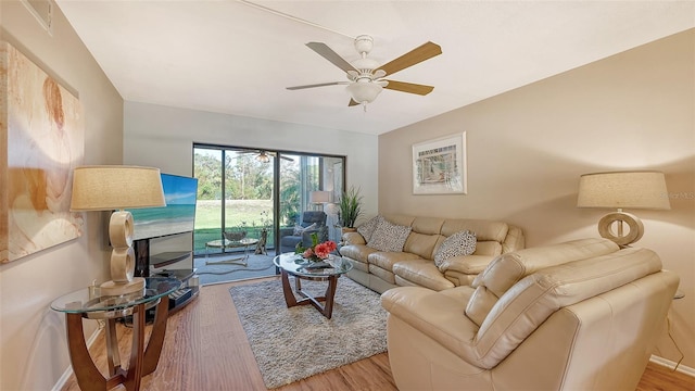 living room with ceiling fan and hardwood / wood-style flooring