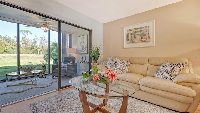 living room with light hardwood / wood-style floors and ceiling fan