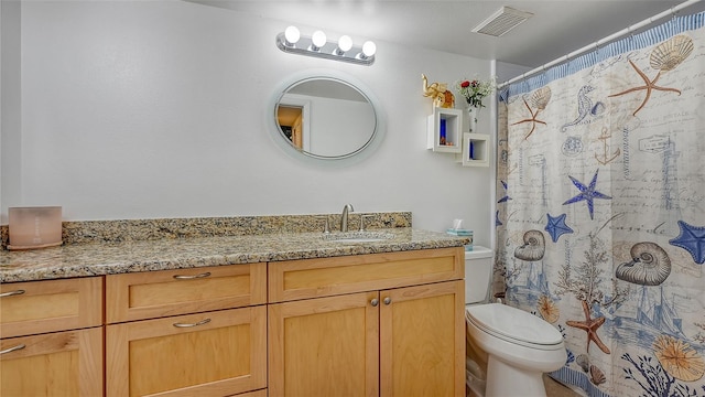 bathroom featuring vanity, curtained shower, and toilet